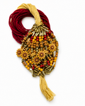 A beaded and woven decorative  featuring yellow-gold floral beads, red and gold seed beads, 