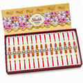 A boxed set of Shubh Rakhi wristbands displayed open in a red tray, with the matching branded box lid shown above. 