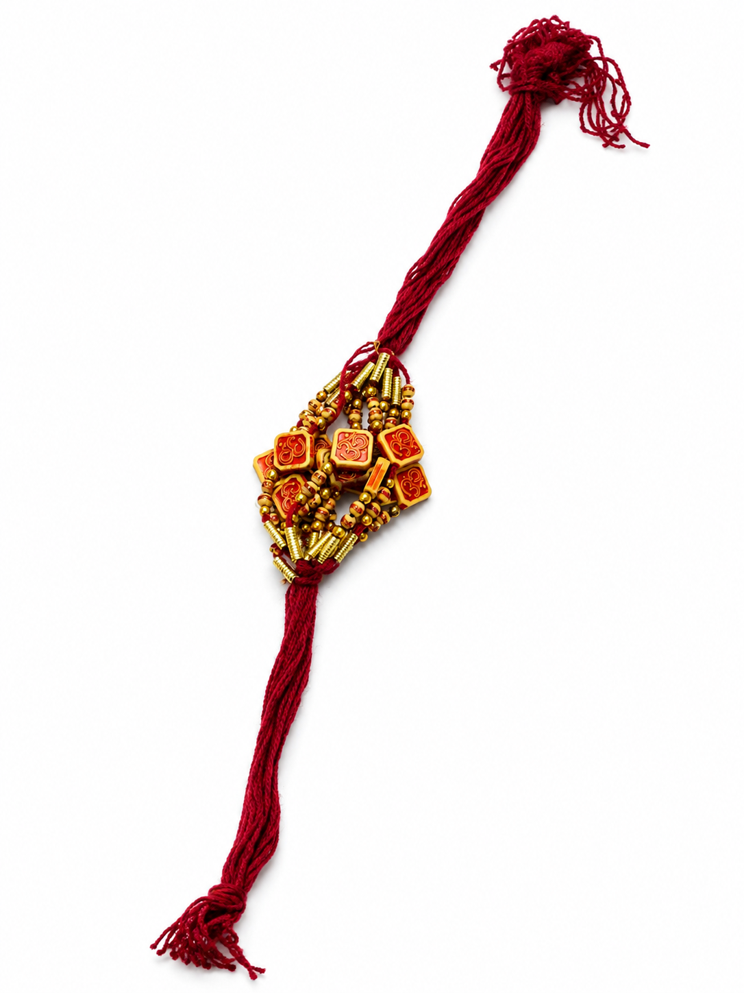 A traditional Indian Rakhi featuring a central cluster of gold-colored beads