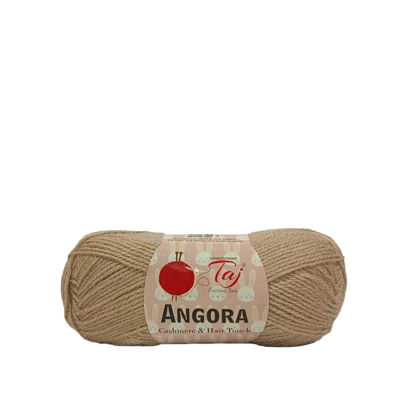 A skein of Taj Angora yarn in a warm beige/tan color, featuring a paper label
