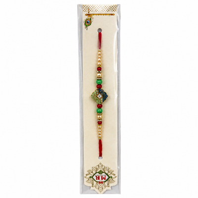 A traditional Indian Rakhi bracelet in its original clear plastic packaging