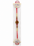 A packaged Jai Shree Lakshmi Rakhi featuring red cord