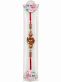 A packaged Jai Shree Lakshmi rakhi featuring a red cord