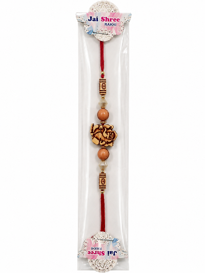 A packaged Jai Shree Lakshmi rakhi featuring a red cord