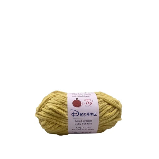 A skein of Dreamz soft crochet bulky fur yarn in a pale yellow color