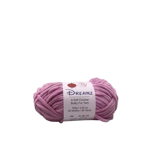 A skein of dusty pink Dreamz Bulky Fuzzy Yarn with a white paper label,