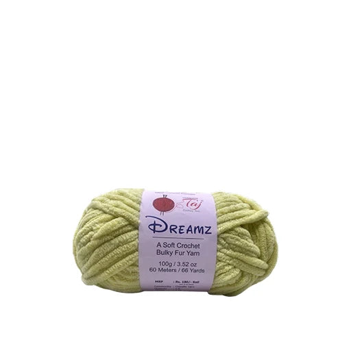 A skein of Dreamz Bulky Fur Yarn in a pale yellow-green color, wrapped with a white paper label