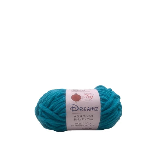 A skein of teal turquoise yarn with a white paper label reading 'Dreamz'