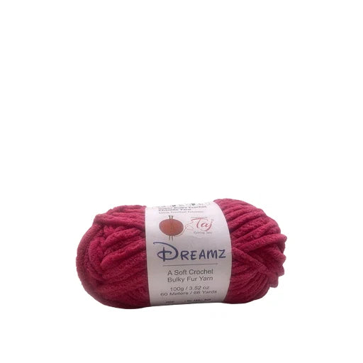 A skein of Dreamz Sulky Fur Yarn in a vibrant magenta-pink color, featuring a white paper 