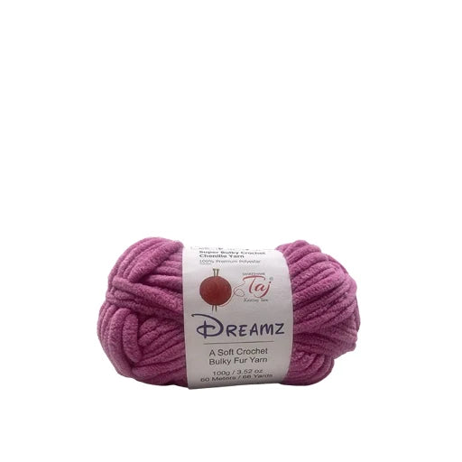 A skein of magenta-pink Dreamz Bulky Fur Yarn with a white paper label,
