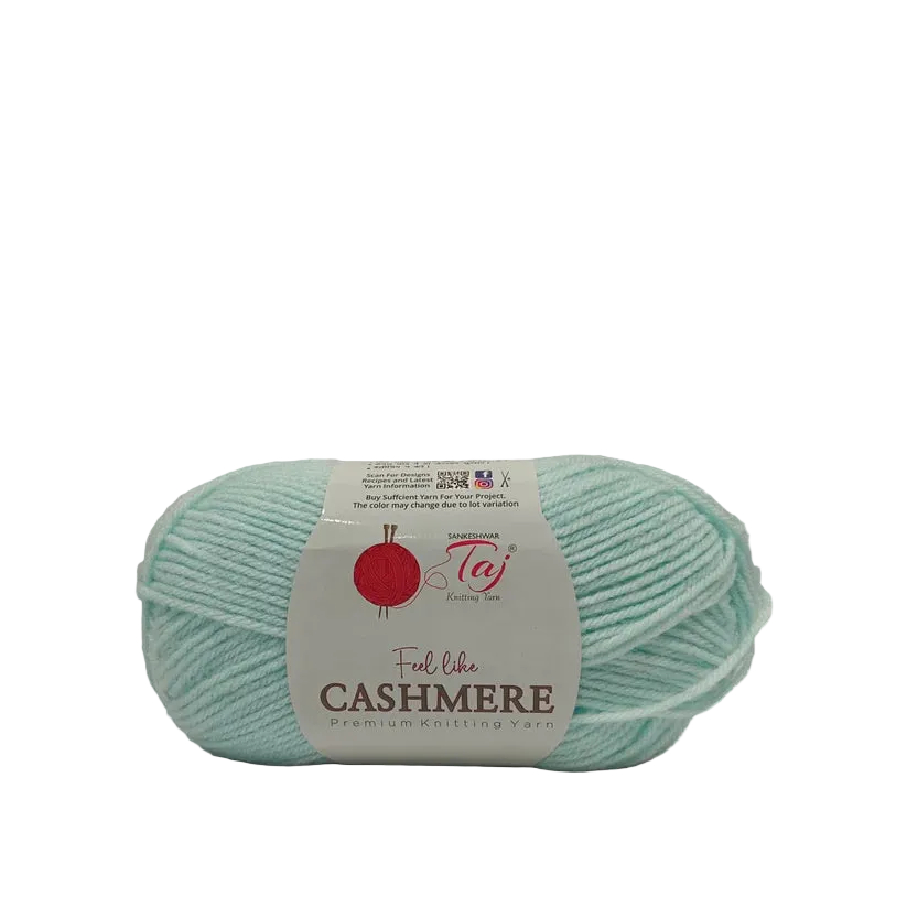 A skein of light mint green cashmere yarn with a white paper label