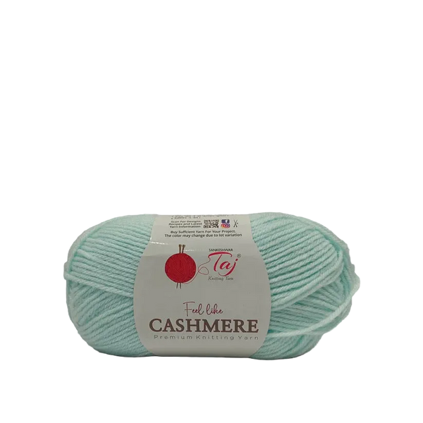A skein of light mint green cashmere yarn with a white paper label
