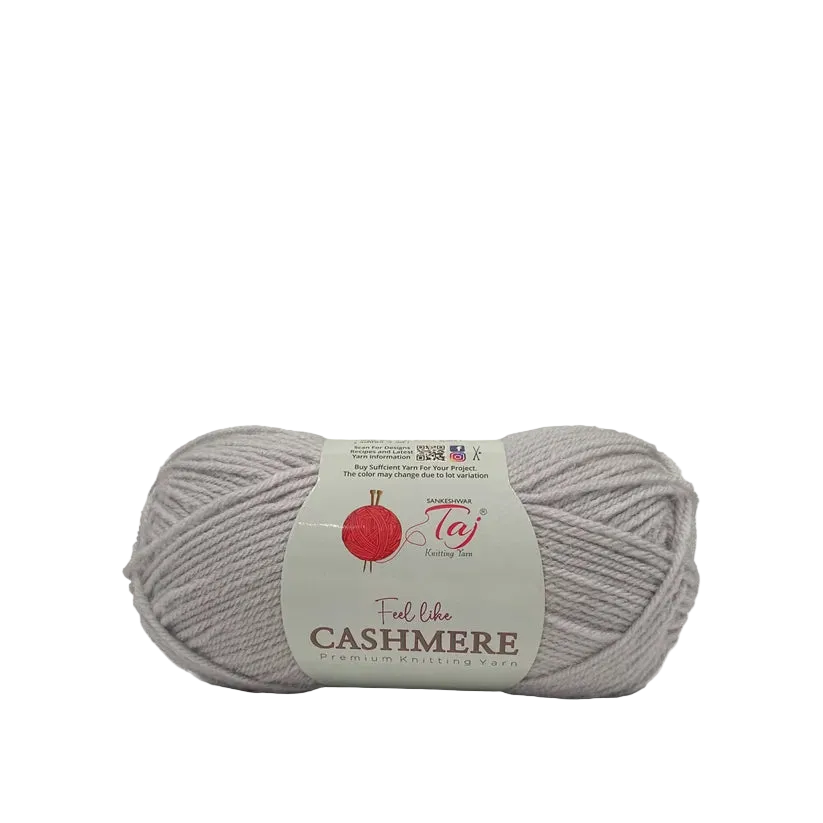 A skein of light gray Cashmere yarn with a white paper label that reads 'Feel like CASHMERE' 