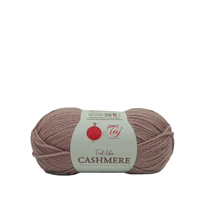 A single skein of dusty mauve-pink yarn with a white paper label reading 'Feel like CASHMERE' 
