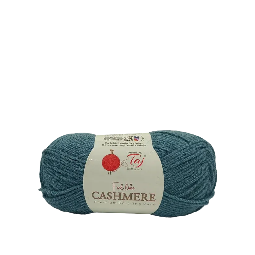A skein of teal blue cashmere yarn with a white paper label wrapped around it