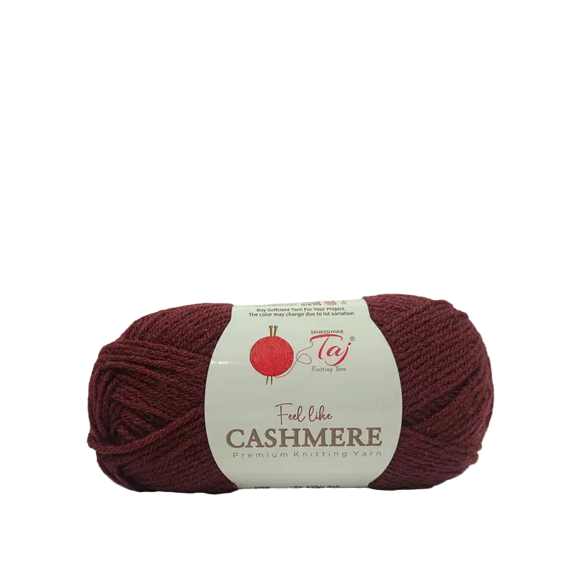 A skein of burgundy yarn with a white paper label that reads 'Feel like CASHMERE premium knitting yarn'