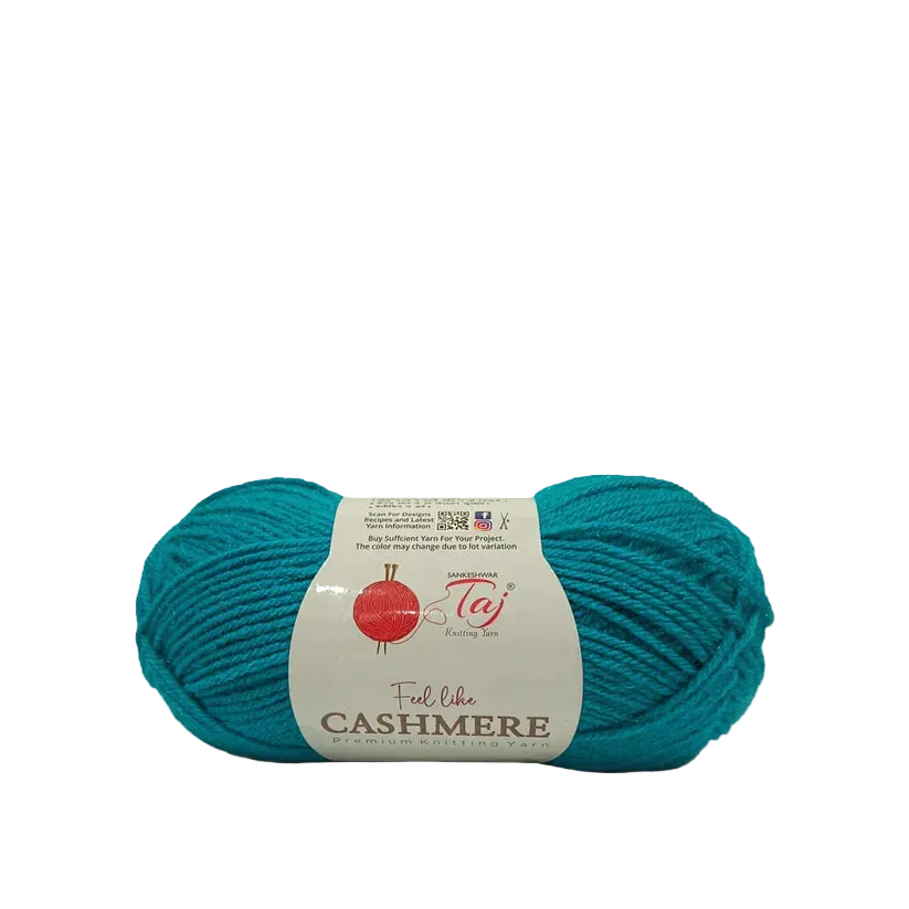A skein of teal cashmere yarn with a white paper label reading 'Feel libre CASHMERE'
