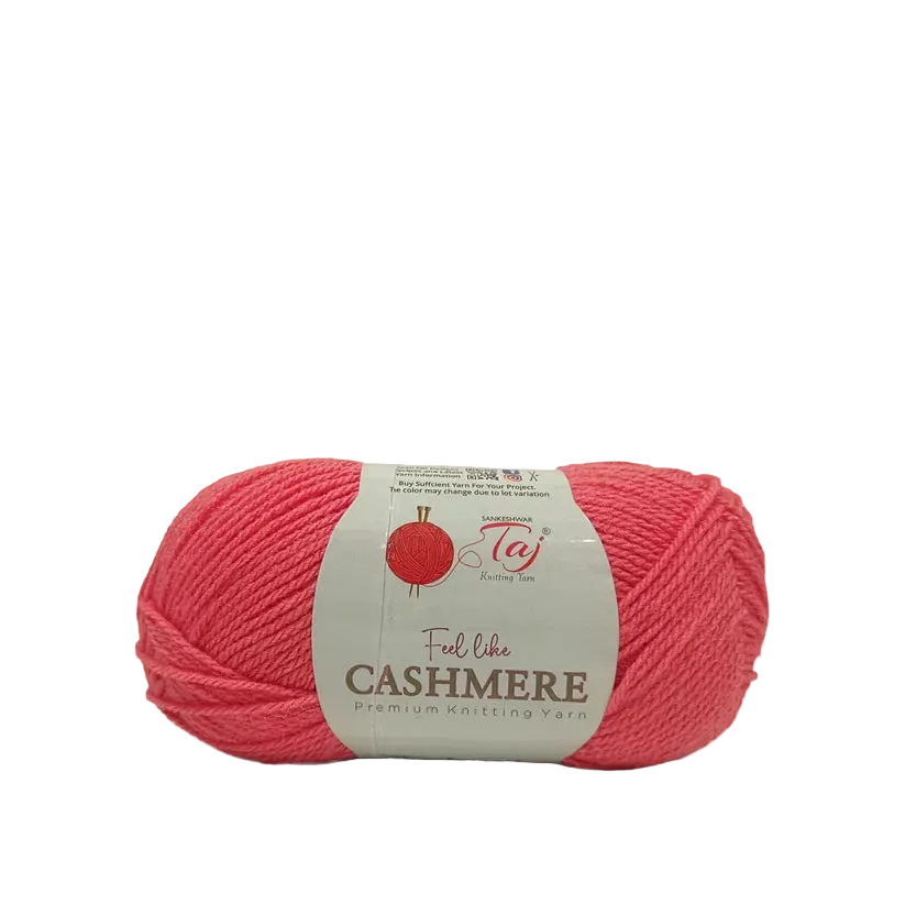 A skein of coral pink yarn with a cream paper label that reads 'Ful like CASHMERE Premium Knitting Yarn'