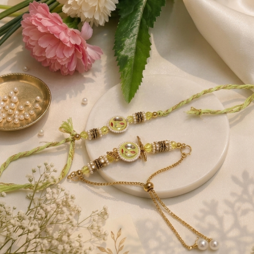 Two decorative baby anklets or rakhi-style jewelry pieces displayed on a white round tray