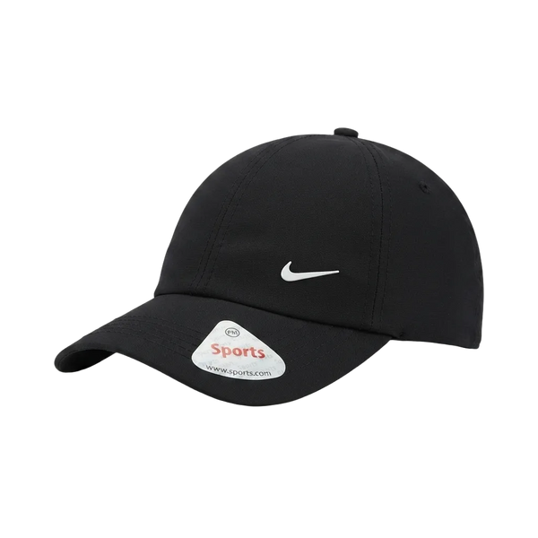 A black Nike baseball cap with a white embroidered Swoosh logo on the front and a white sticker on the brim, photographed on a clean white background.