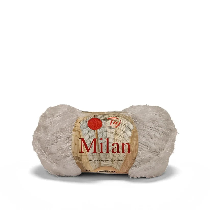A skein of fluffy yarn in a light beige color with a paper label that reads 'Milan'