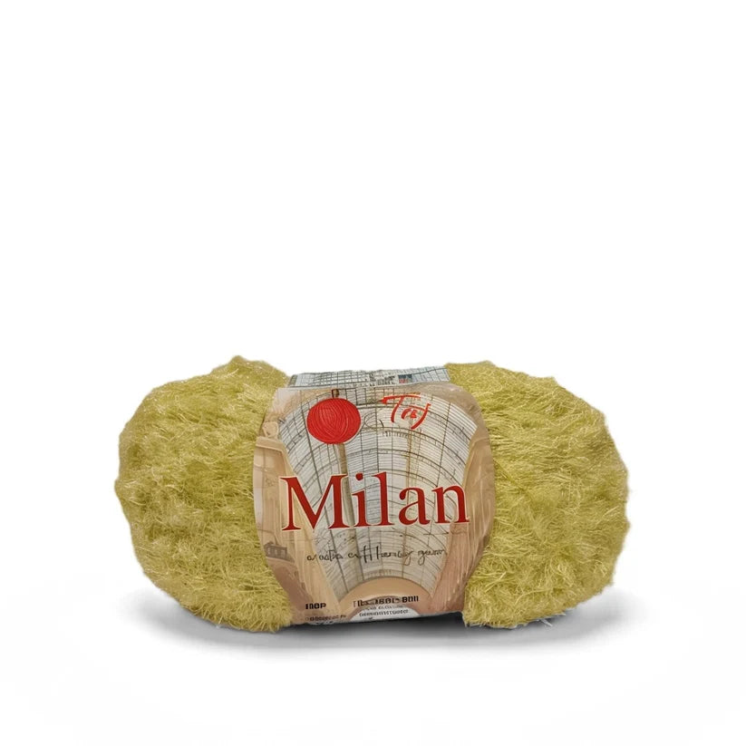 A ball of Milan brand fuzzy yellow-green yarn with its paper label wrapper, shown on a plain white background.