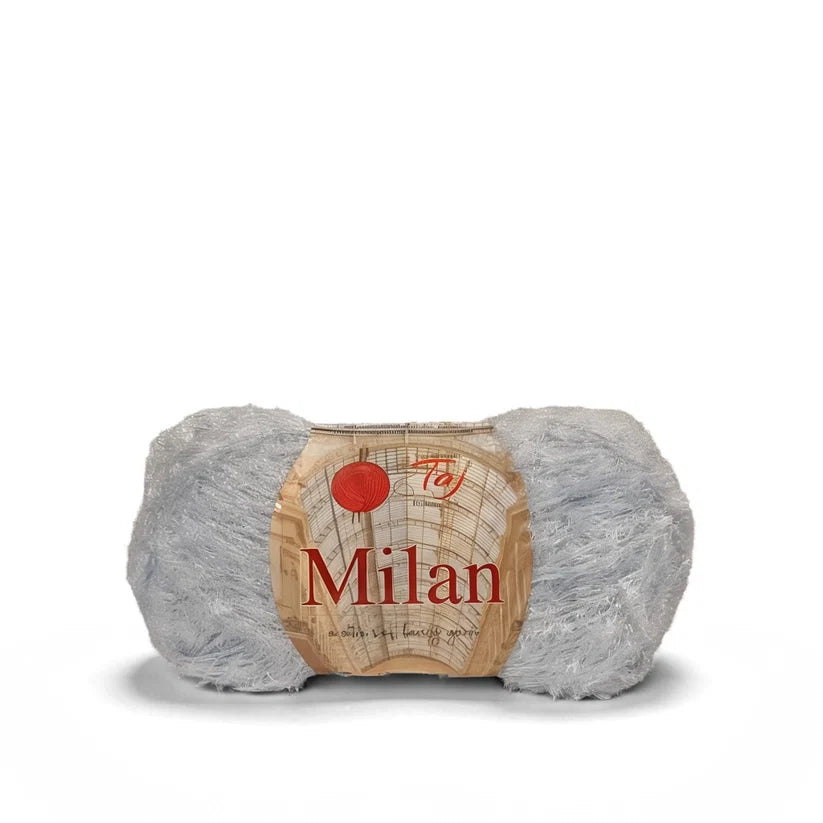 A single skein of light gray fluffy yarn with a paper label that reads 'Tay Milan' on a white background.