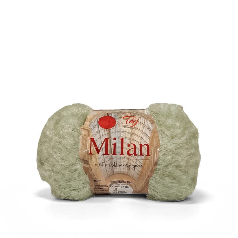 A single skein of light sage green yarn with a paper label wrapped around it,