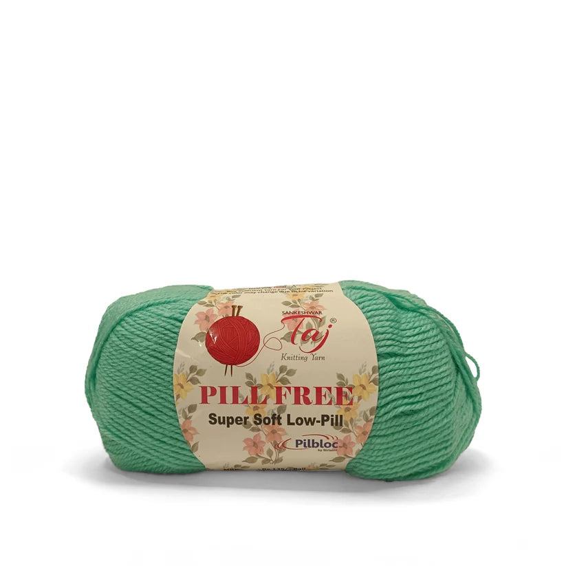 A skein of mint green yarn with a cream-colored paper label that reads 'PILL-FREE Super Soft Low-Pill'