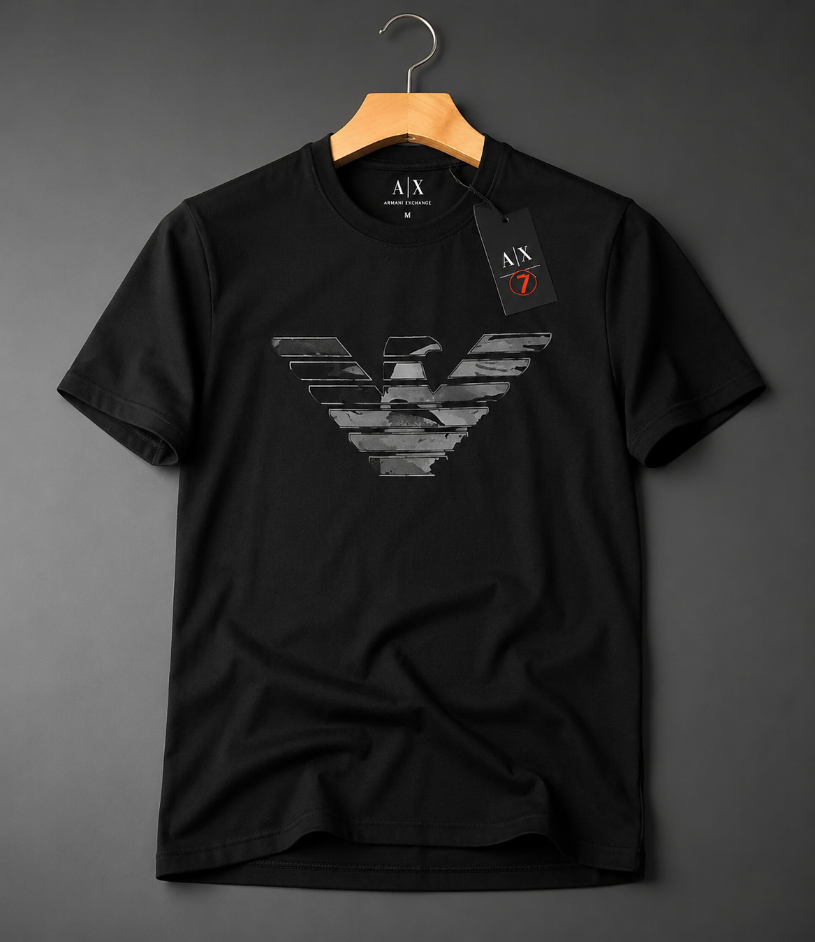 A black short-sleeve crewneck t-shirt by Armani Exchange, featuring a large distressed gray eagle logo on the front