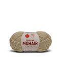 A skein of beige mohair yarn with a white paper label that reads 'TOUCH ME MOHAIR'