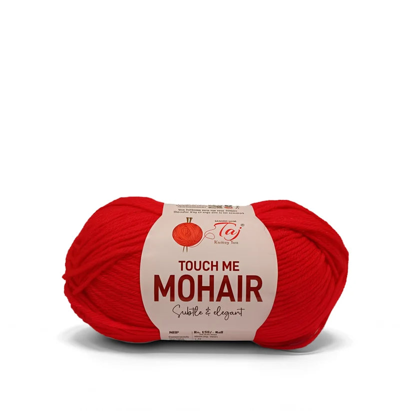 A skein of bright red mohair yarn with a cream-colored paper label reading 'TOUCH ME MOHAIR'