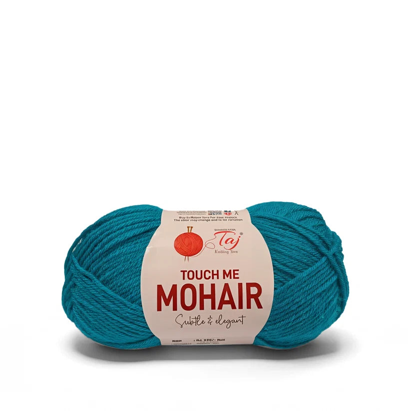 A skein of teal mohair yarn with a cream paper label that reads 'TOUCH ME MOHAIR' 
