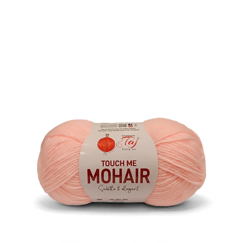 A single ball of light pink mohair yarn with a paper label reading 'TOUCH ME MOHAIR'