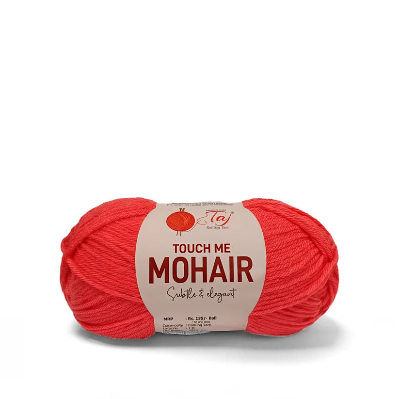 A ball of bright red mohair yarn with a paper label reading 'TOUCH ME MOHAIR'