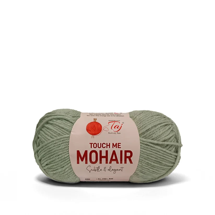 A single skein of teal yarn with a beige paper label that reads 'TOUCH ME MOHAIR' 

