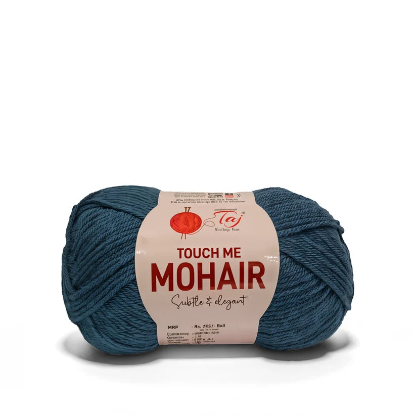 A single ball of teal blue mohair yarn with a paper label that reads 'TOUCH ME MOHAIR'