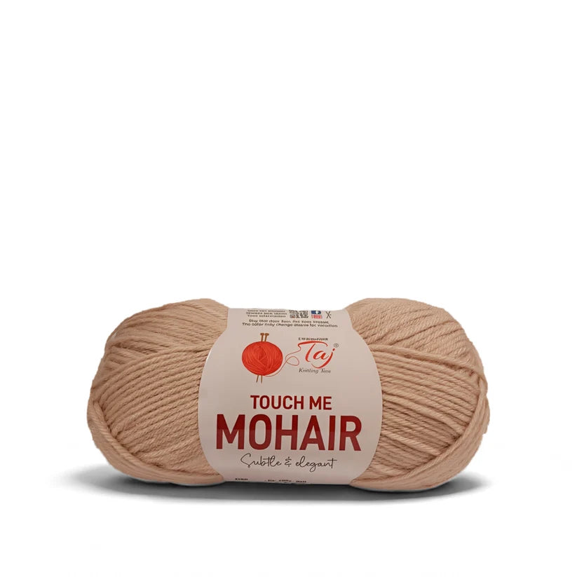 A skein of Touch Me Mohair yarn in a soft beige color, featuring a white paper label