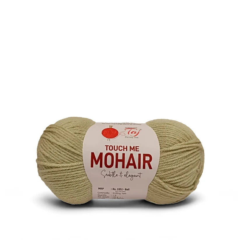A single ball of Touch Me Mohair yarn in a light beige/olive shade, featuring a white paper label
