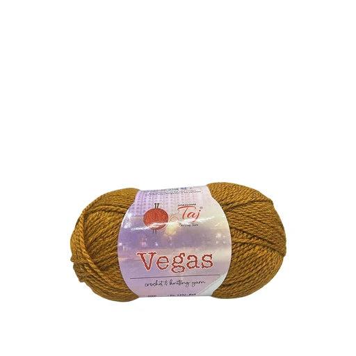 A skein of mustard yellow Taji Vegas crochet and knitting yarn with a white paper label,