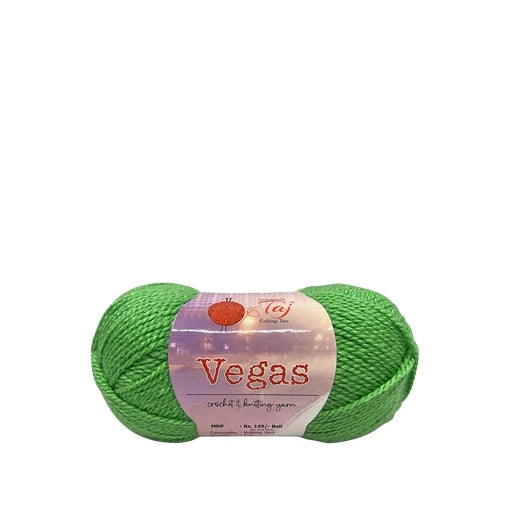 A bright green ball of yarn with a paper label reading 'Vegas crochet & knitting yarn' and the CJ Knitting Co.
